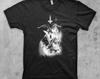 May include: Black t-shirt with a white graphic print of a goat's head with horns and an inverted pentagram above it.