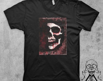 May include: Black t-shirt with a graphic of a white skull with red blood dripping from the eyes and mouth. The skull is on a dark red background.