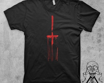May include: Black t-shirt with a red upside-down cross dripping with blood.