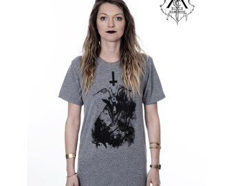 May include: A heather grey t-shirt with a black and white graphic print of a goat's head with an upside down cross above it.