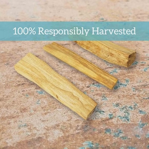 May include: Three pieces of light brown palo santo wood, arranged on a textured surface. The text "100% Responsibly Harvested" is displayed above the wood.