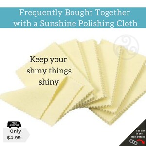 May include: A stack of yellow polishing cloths with the text "Keep your shiny things shiny" on top. The cloths are folded in a fan shape and have a scalloped edge. The text "Free Shipping" and "Only $4.99" is visible in the lower left corner of the image.