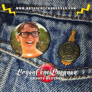 May include: A round button featuring a close-up image of a young boy with glasses smiling. The boy is wearing a white shirt and is in a swimming pool. The button is on a blue denim background. The text "www.bryanchuckbrennan.com" is visible at the top of the image.