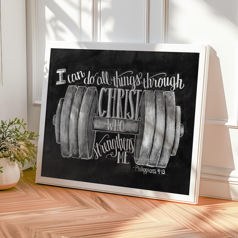 May include: A framed chalkboard art print with a white border. The black chalkboard features a barbell illustration and the text "I can do all things through Christ who strengthens me - Philippians 4:13" in white.