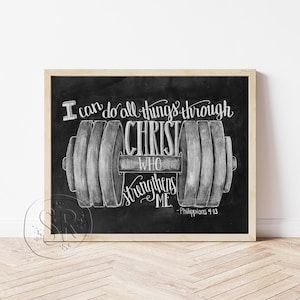 May include: Black chalkboard art print with a wooden frame. The artwork features a dumbbell illustration with the text "I can do all things through Christ who strengthens me" and the Bible verse Philippians 4:13.
