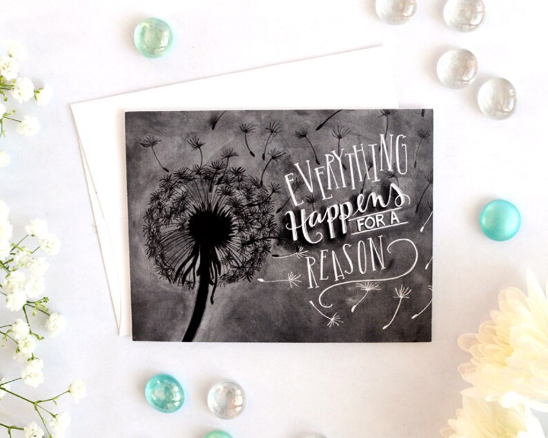 May include: A black and white illustration of a dandelion with the text "Everything Happens for a Reason" written in white on a gray background.