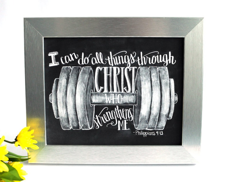 May include: A black and white chalkboard with a silver frame. The chalkboard has a drawing of a dumbbell with the text "I can do all things through CHRIST who strengthens ME. - Philippians 4:13"