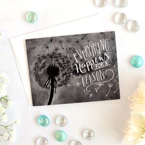 May include: A black and white card with a dandelion illustration and the text "Everything Happens for a Reason".