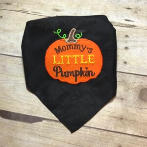 May include: Black fabric bandana with an orange pumpkin design that says "Mommy's Little Pumpkin" in brown and yellow embroidery.