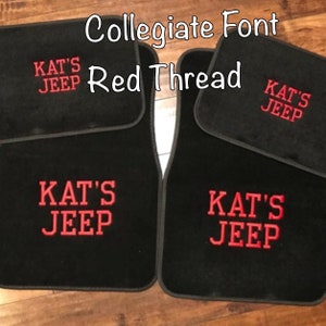 May include: Four black car floor mats with red embroidered text that reads "KAT'S JEEP" in a collegiate font. The text "Red Thread" is written in a larger font above the mats.