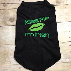 May include: Black dog shirt with green embroidery that says "Kiss Me I'm Irish" and a green lip design.