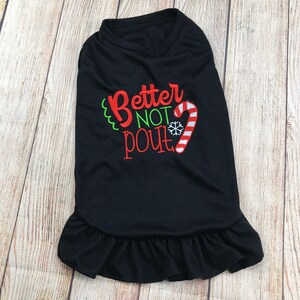 May include: Black dog shirt with a red and white candy cane and snowflake design. The shirt says "Better Not Pout".