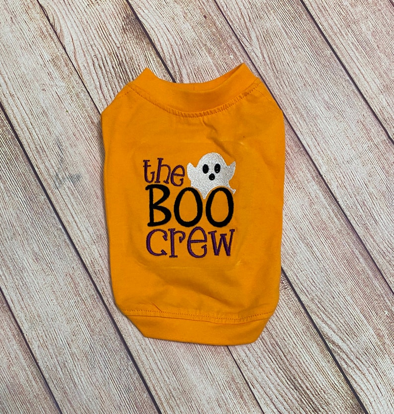 May include: A yellow dog shirt with the text "the BOO crew" and a white ghost graphic.