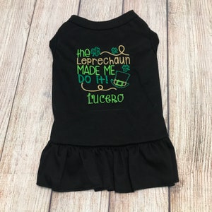 May include: Black dog dress with a green and gold embroidered design that says "The Leprechaun Made Me Do It!" with a leprechaun hat and the name "Lucero" embroidered below.