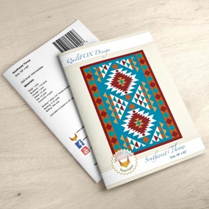 Puede incluir: Un patrón de acolchado para una colcha Southwest Throw. El patrón presenta un diseño geométrico con colores rojo, naranja, turquesa, blanco y marrón. El patrón mide 56 pulgadas por 82 pulgadas.