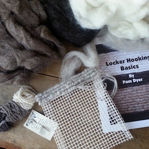 May include: A rug hooking kit with brown, white, and black wool yarn, a white mesh canvas, and instructions for "Locker Hooking Basics" by Pam Dyer.