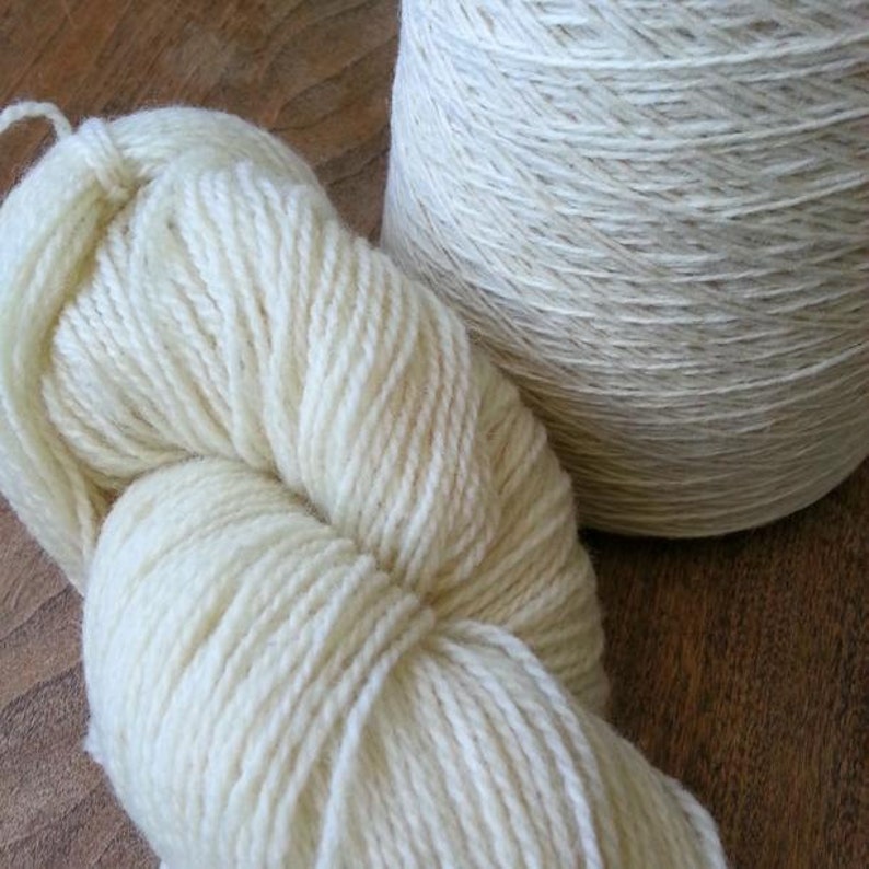 May include: Two skeins of white yarn, one wound into a ball and the other in a skein.