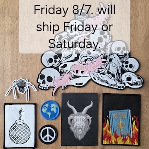 May include: A collection of embroidered patches including a large pile of skulls and bones, a spider, a bomb, a globe, a peace sign, a goat head, and a book in flames. Text overlay reads: backordered until Friday 8/7. will ship Friday or Saturday.