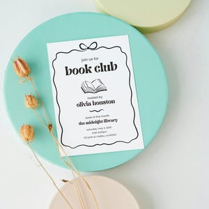 May include: A white invitation card with black text and a simple illustration of an open book. The invitation is for a book club hosted by Olivia Houston. The event will take place on Saturday, May 3, 2025, at 6:00-8:00pm at the Midnight Library, located at 123 Pine St, Malibu, CA 90263.