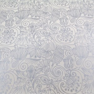 May include: A white background with a silver floral pattern. The pattern is made up of swirls, leaves, and flowers.