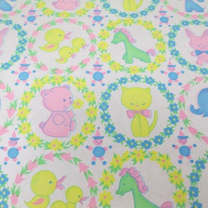 May include: A white background with a repeating pattern of colorful animals and flowers. The animals include a pink bunny, a green giraffe, a yellow cat, a pink bear, a blue elephant, and a yellow duck. The flowers are yellow, pink, and blue.