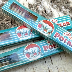 May include: Vintage Pacific Polar Bear brand toothbrushes in their original packaging. The boxes are teal with white stripes and feature a polar bear illustration. The text "British Empire Made Brand" is visible.