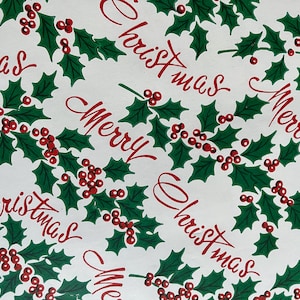 May include: White wrapping paper with a repeating pattern of green holly leaves, red berries, and the words "Merry Christmas" in red.