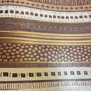 May include: A brown and gold patterned wallpaper with a repeating geometric design. The pattern includes circles, squares, and lines.