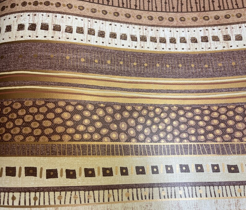May include: A brown and gold patterned wallpaper with a repeating geometric design. The pattern includes circles, squares, and lines.