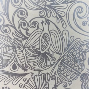 May include: A black and white illustration of a bird with intricate floral designs surrounding it. The bird has a long beak and a rounded body. The floral designs are detailed and include leaves, swirls, and other patterns.
