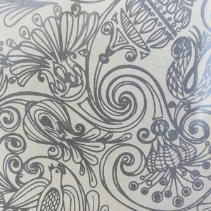 May include: A black and white patterned design with intricate swirls and floral motifs. The design features a repeating pattern of stylized flowers and leaves.