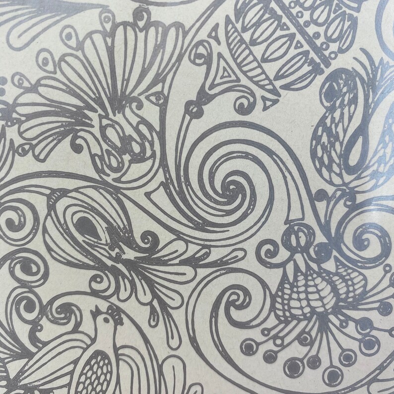May include: A black and white patterned design with intricate swirls and floral motifs. The design features a repeating pattern of stylized flowers and leaves.