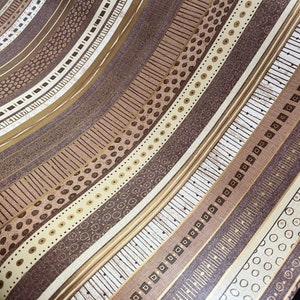 May include: A brown and beige patterned wallpaper with a repeating geometric design. The wallpaper has a subtle shimmer and a textured surface.