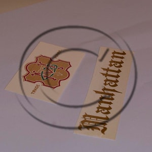 May include: Two vintage labels, one with a gold and red crest and the word "TRADE" and the other with the word "Manhattan" in gold script.