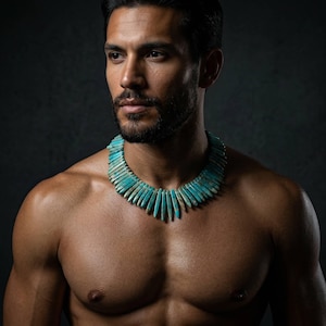 May include: A statement necklace featuring numerous elongated, tapered turquoise stone beads arranged in a dense, fringe-like collar formation. The vibrant blue-green stones display natural brown matrix veining throughout each individual piece.