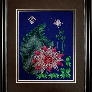 May include: A framed cross-stitch embroidery featuring a stylized flower with pink and red petals, green leaves, and a small butterfly in the upper right corner. The background is a dark blue fabric.