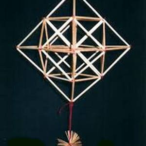 May include: A geometric, three-dimensional structure made of thin, light brown sticks, tied together with red string. The structure is suspended from a red string and has a small, round, brown and white tassel at the bottom.