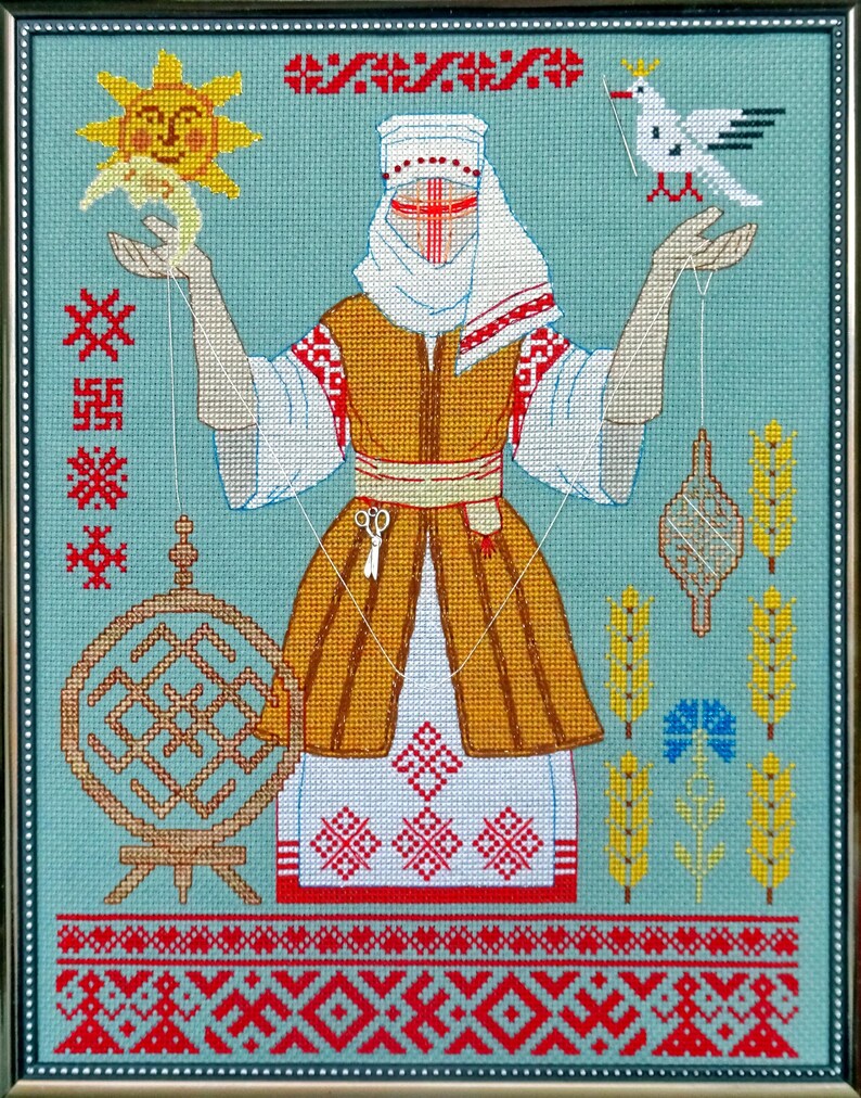 May include: Framed cross-stitch artwork depicting a central figure in traditional dress, holding objects connected by threads. The figure is surrounded by symbolic elements, including a sun, a bird, and geometric patterns. The color palette includes gold, red, white, and blue.