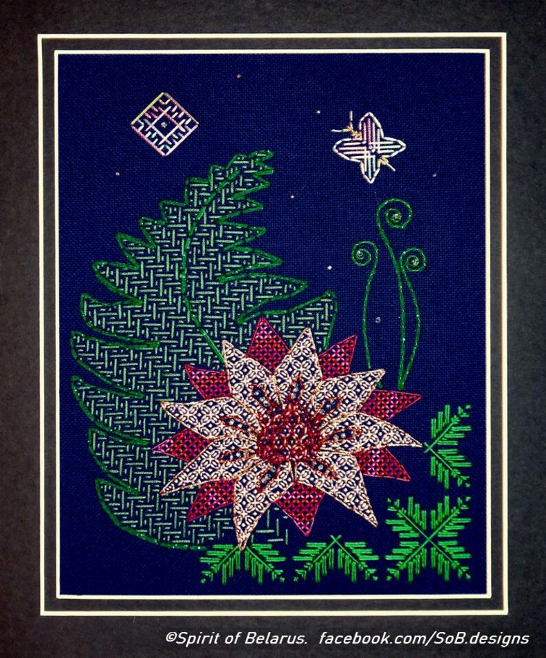 May include: A framed cross-stitch embroidery featuring a pink and white flower with green leaves and a butterfly on a dark blue background. The text "@Spirit of Belarus. facebook.com/SoB.designs" is at the bottom of the image.