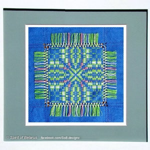May include: A framed blue and white cross-stitch design with green, pink, and white embroidery. The design features a geometric pattern with a central star shape. The frame is gray with a white mat.