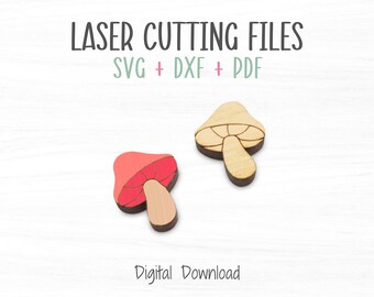 Puede incluir: Dos formas de hongo cortadas con láser, una roja y otra de madera natural. El texto "LASER CUTTING FILES SVG + DXF + PDF" está por encima de los hongos. El texto "Descarga digital" está debajo de los hongos.
