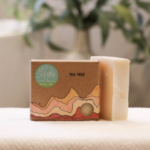 May include: A bar of soap with a brown paper wrapper. The wrapper has a green tree logo and the text "Bona Fide Tea Tree".