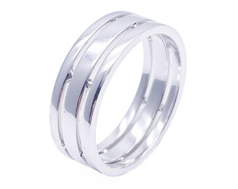May include: A silver band ring with a double-band design. The ring has a smooth, polished finish.