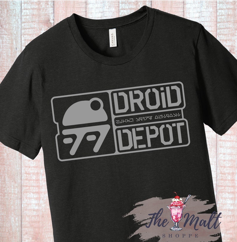 May include: Black t-shirt with a gray graphic of a droid head and the text "DROID DEPOT" in a stylized font.