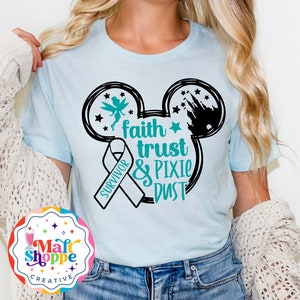 May include: A light blue t-shirt with a black Mickey Mouse silhouette. The silhouette includes a Tinkerbell fairy and a silhouette of Cinderella's castle. The text "faith trust & pixie dust" is written in teal and white. A white ribbon with the word "survivor" is also included.