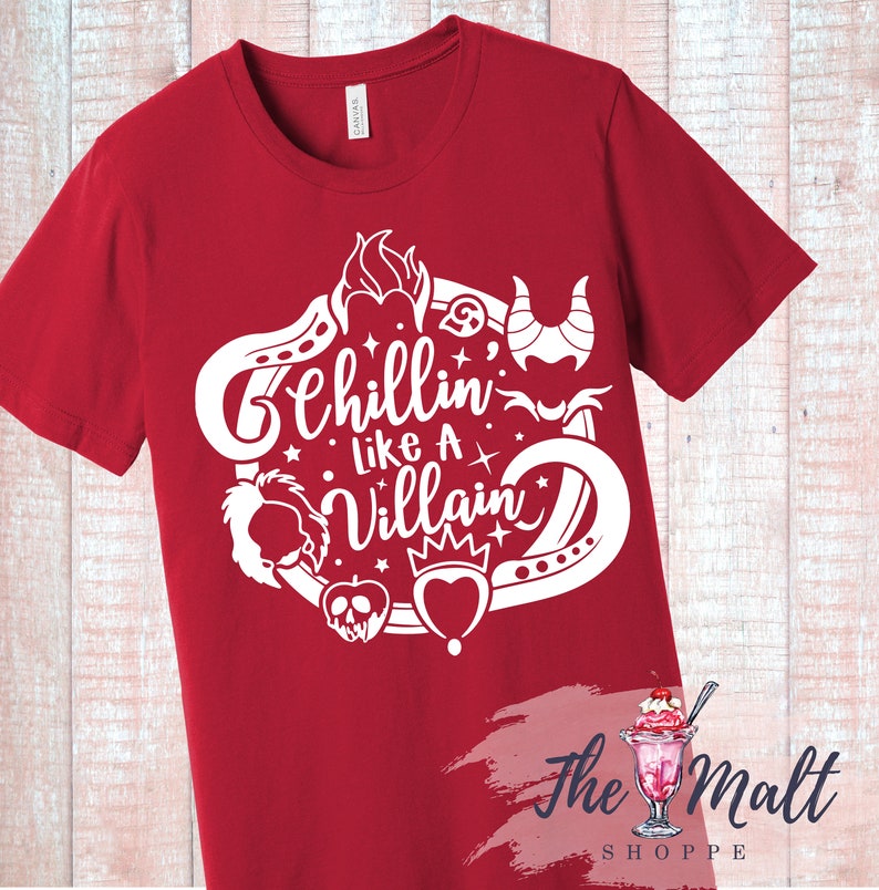 May include: Red t-shirt with a white design featuring the text "Chillin' Like A Villain" surrounded by various Disney villain icons.