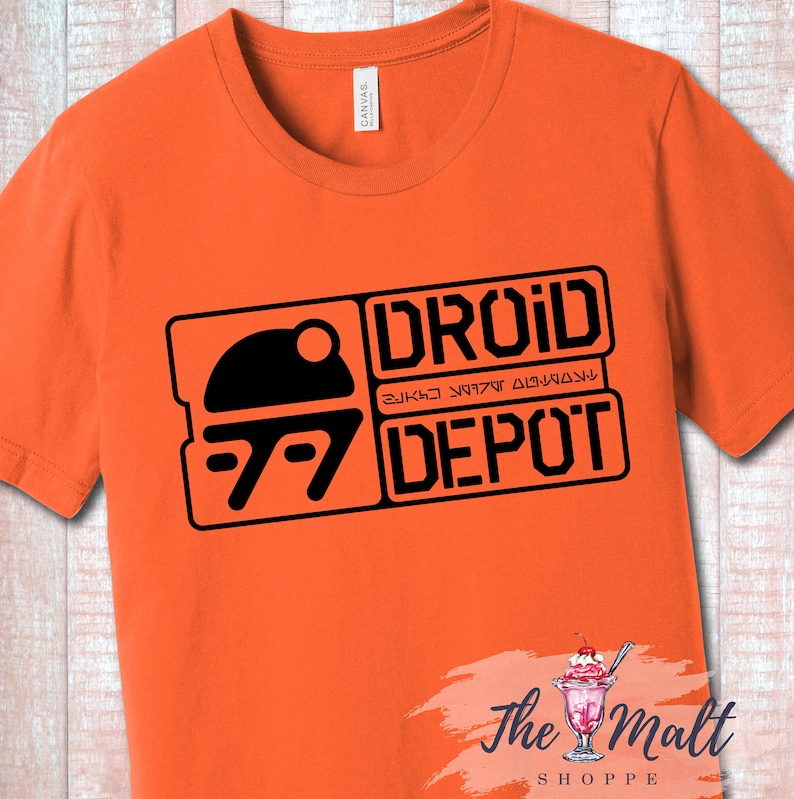 May include: Orange t-shirt with a black graphic of a droid head and the text "DROID DEPOT" in a rectangular box.