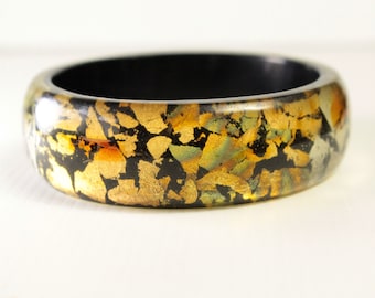 Gold and Silver Cuff Bangle. Gold and Silver metal flakes with a black interior layer 1980s vintage plastic jewellery