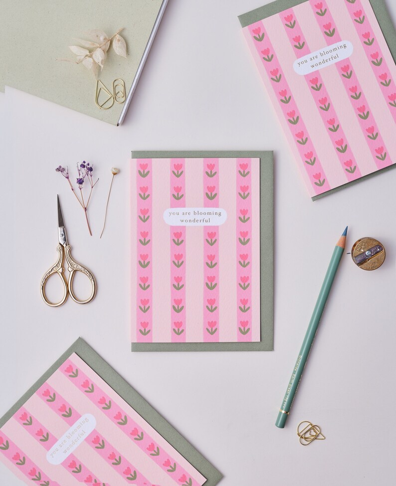 May include: Three pink and green greeting cards with a repeating pattern of pink tulips and the text "you are blooming wonderful".