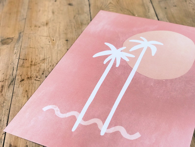 May include: A pink and white print with two palm trees and a large orange sun. The print has a wavy line at the bottom, representing the ocean.